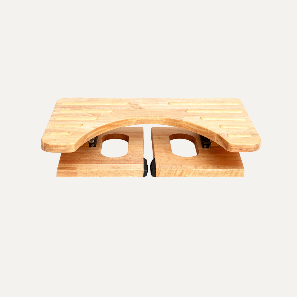 Folded wooden toilet footstool on a white background