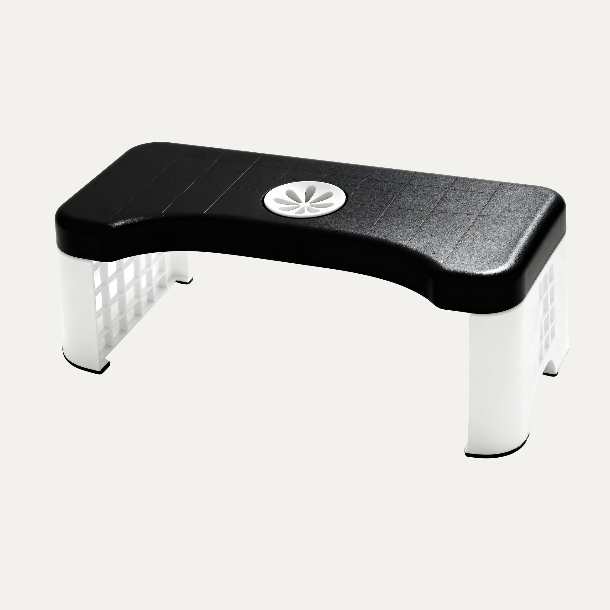 Toilet footstool with black top and white legs on a light gray background