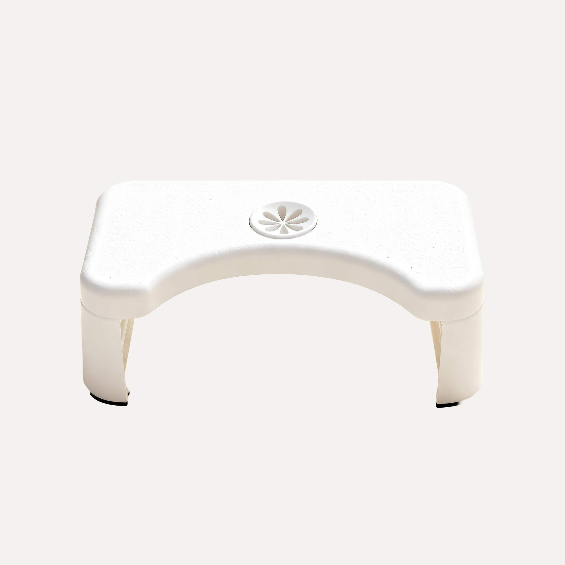 White plastic squatbuddy toilet stool on a white background