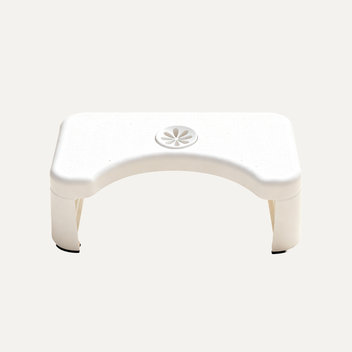 White plastic squatbuddy toilet stool on a white background