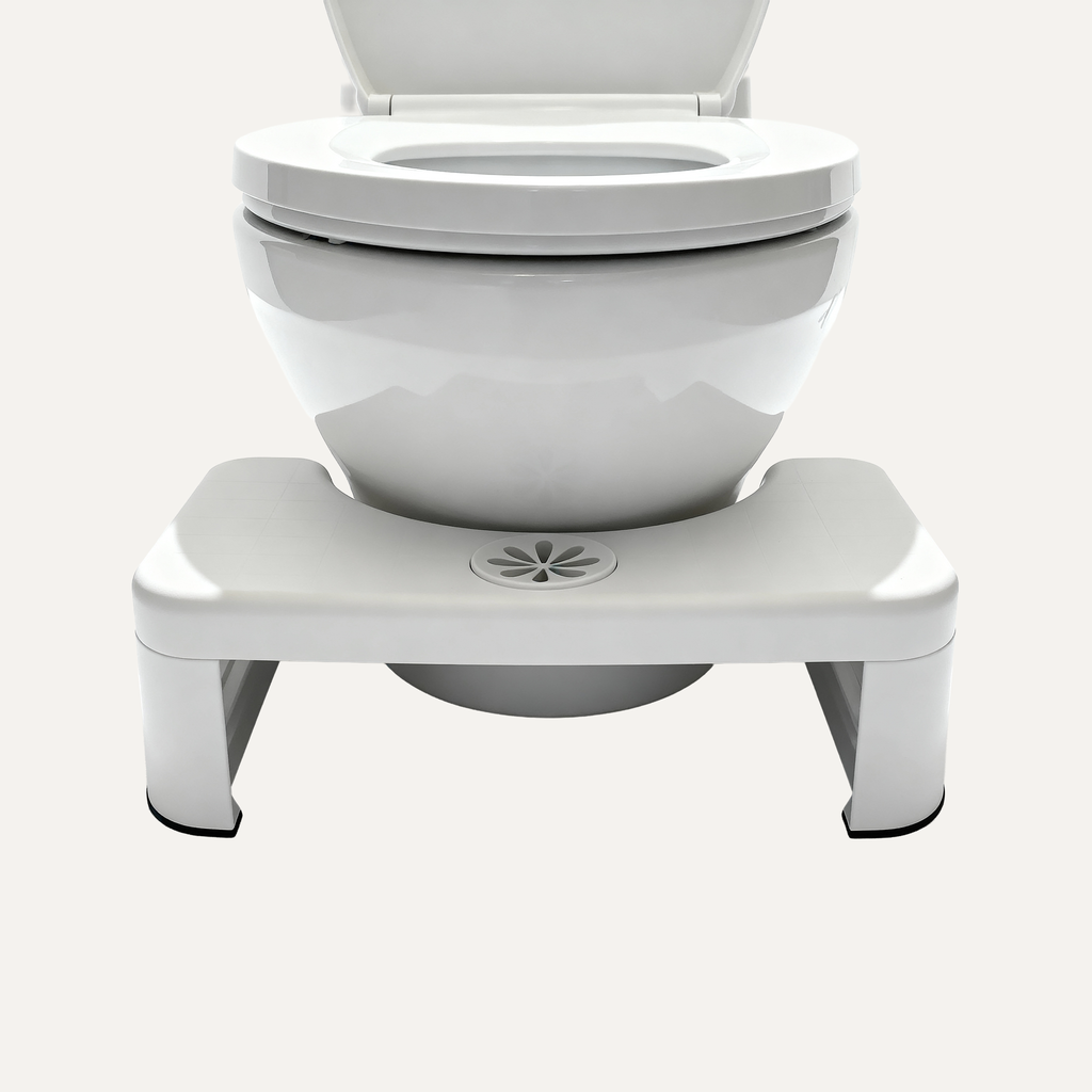 White toilet with a white footstool right beneath it on a white background